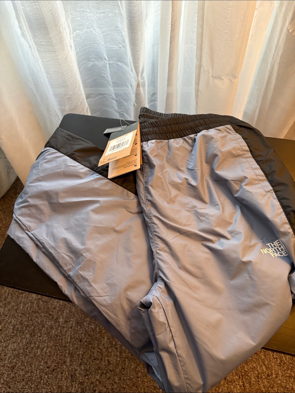The North Face woman’s Windbreaker Joggers in Light Gray with Black Trim